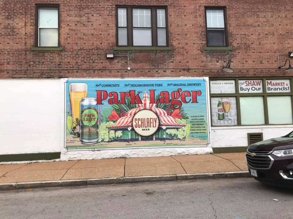 The side of the Shaw Market building showing the painted lager mural and the store signage
